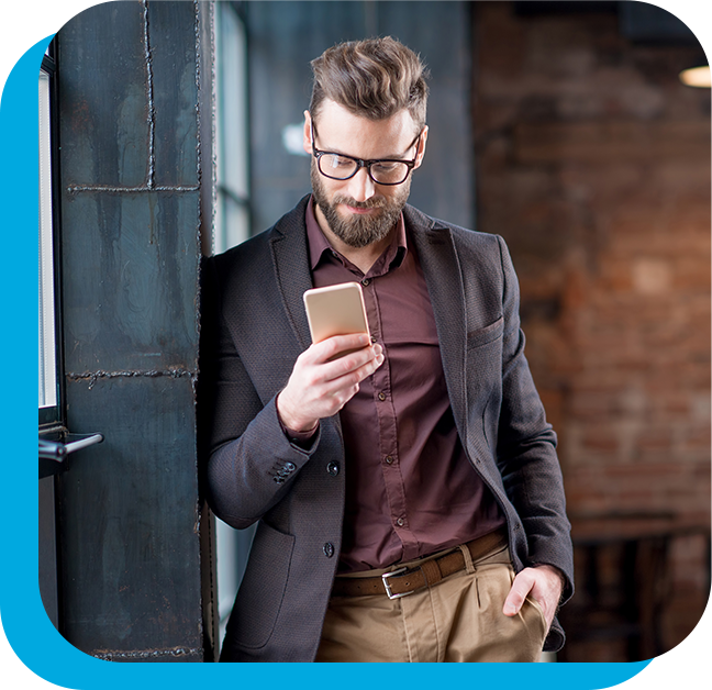 Smart looking man on a phone leaning on a wall